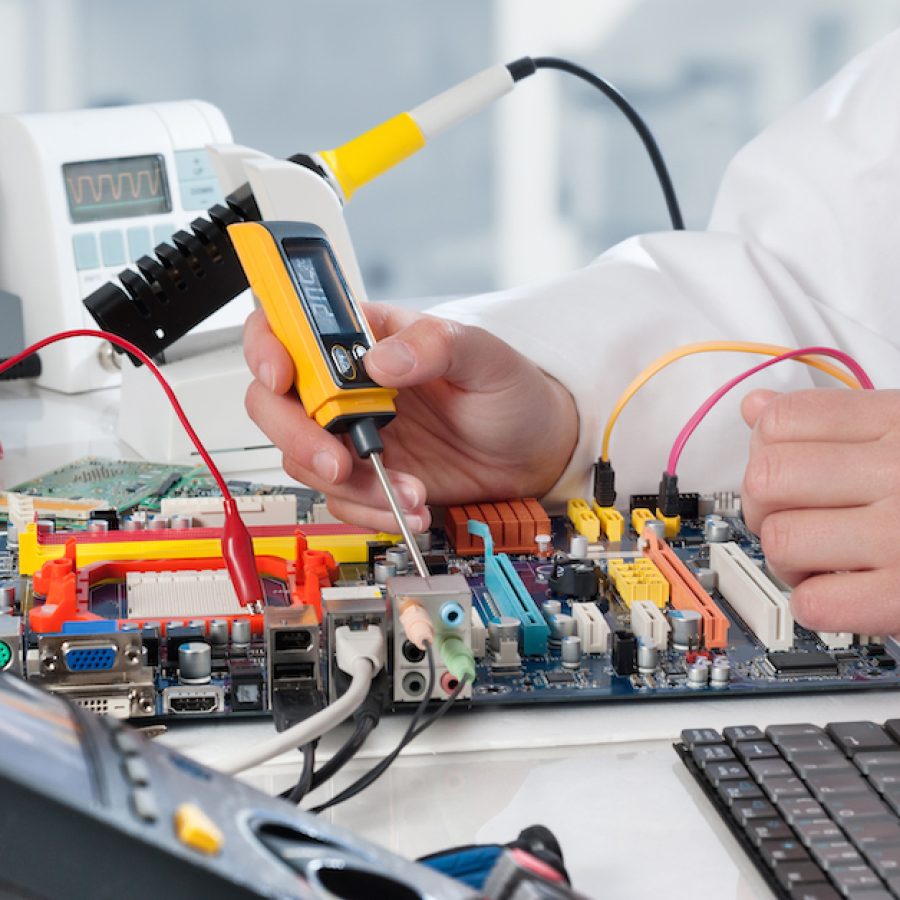 Repairman fixes electronic equipment in service center